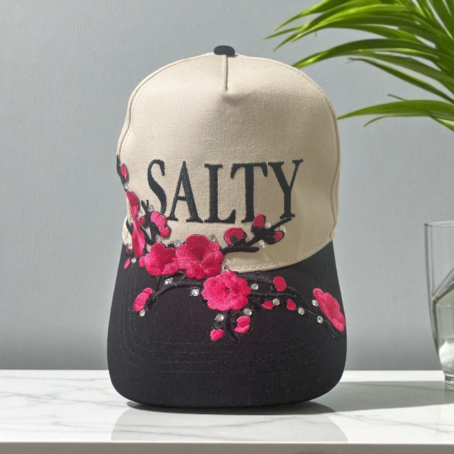 Salty Blossom Two-Tone Trucker Hat – Cream & Black Snapback with Pink Floral Embroidery & Rhinestones