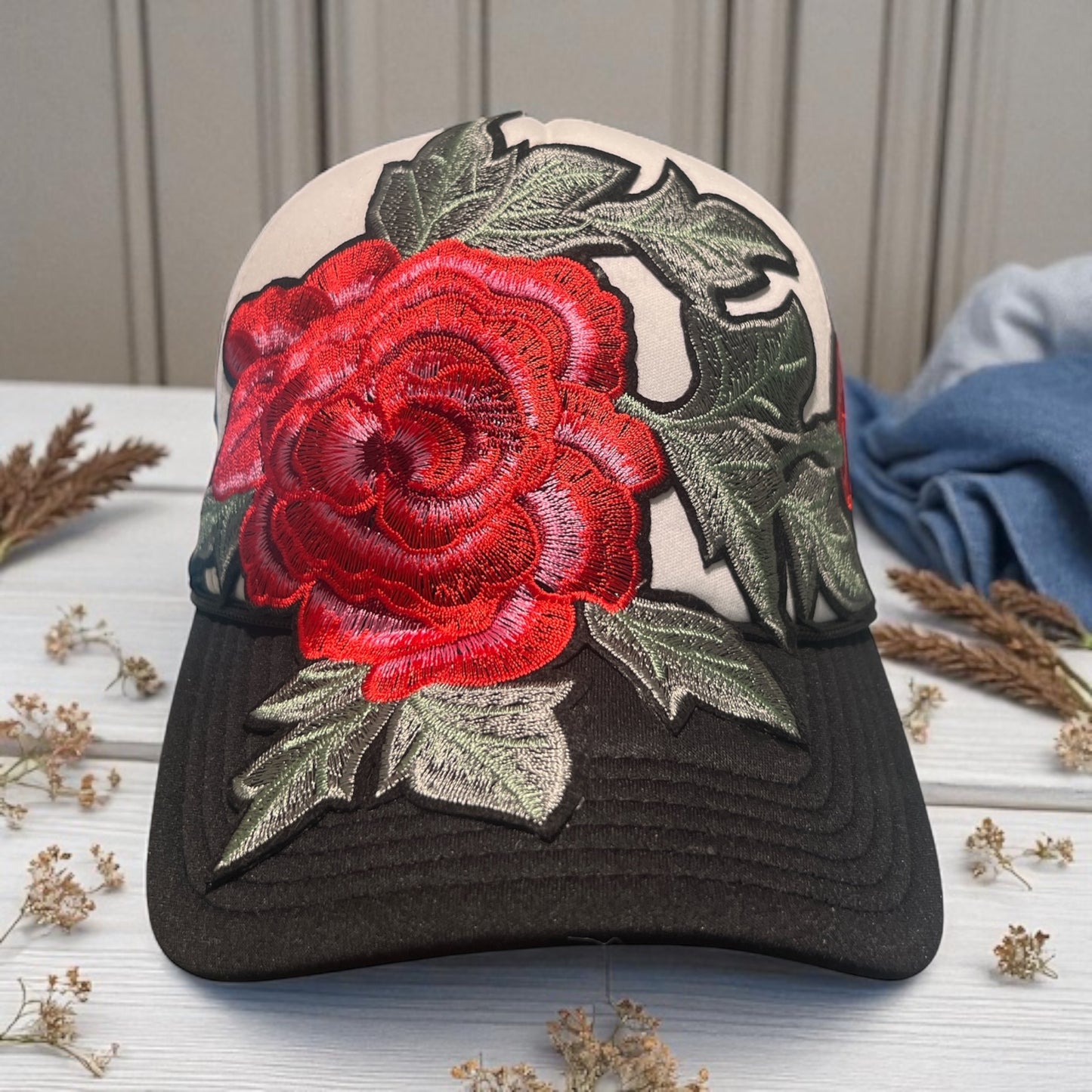 Bold Bloom Trucker Hat – Black Mesh Snapback with White Front & Red Floral Embroidery