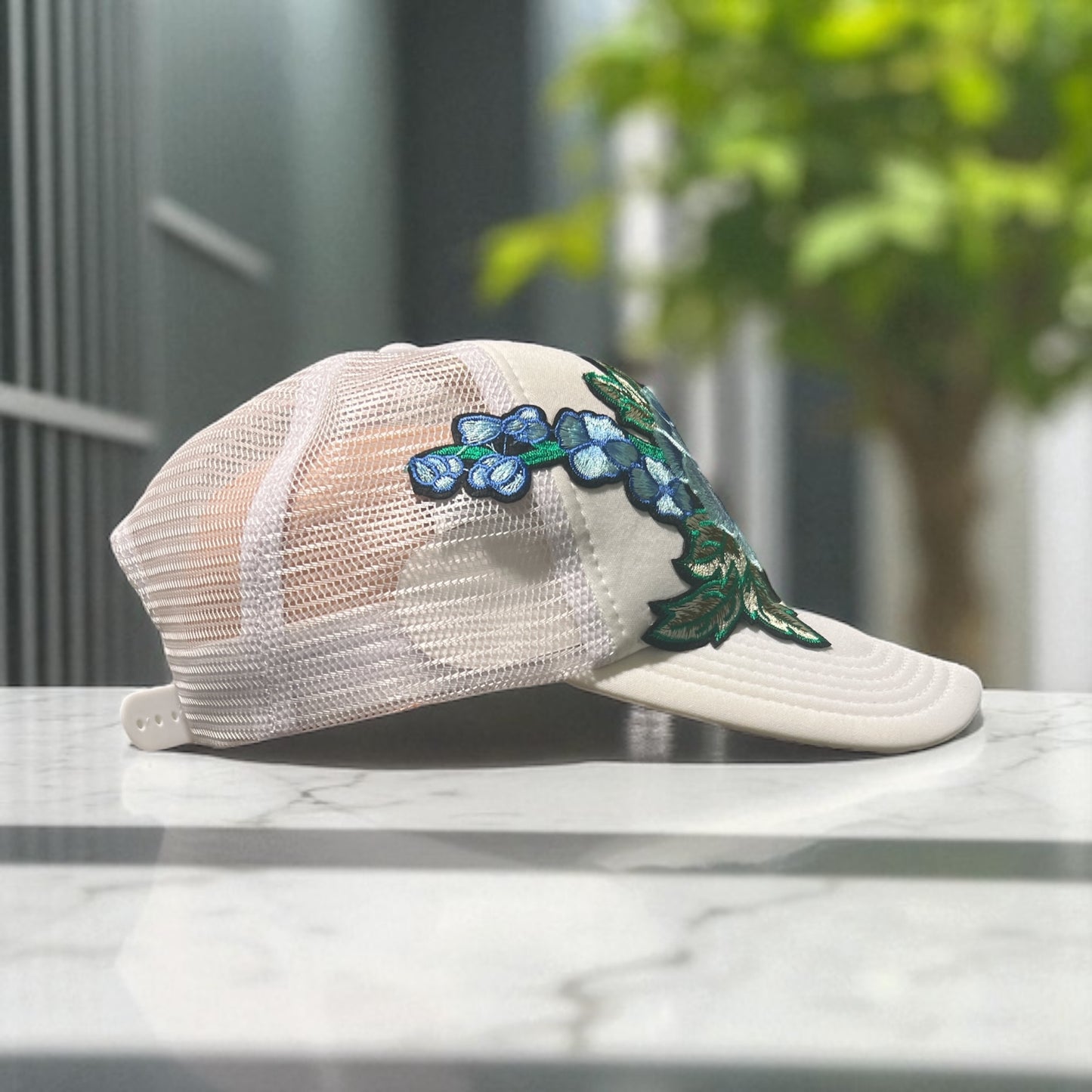 All-White Trucker Hat with Baby Blue Floral Embroidery – Mesh Snapback