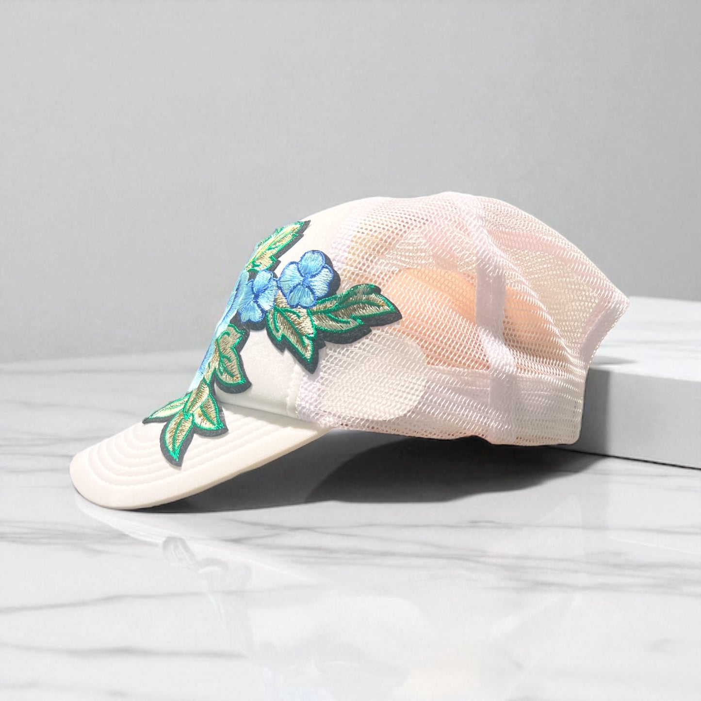 All-White Trucker Hat with Baby Blue Floral Embroidery – Mesh Snapback